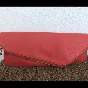 Coral Mudd Pie magnetic fold-over clutch.